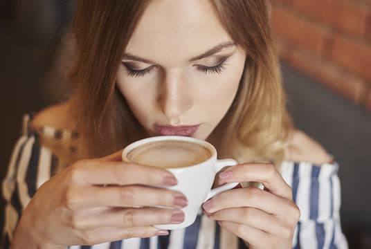 Headshot of woman drinking coffee