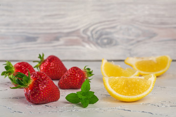 strawberry with lemony mint on white stone