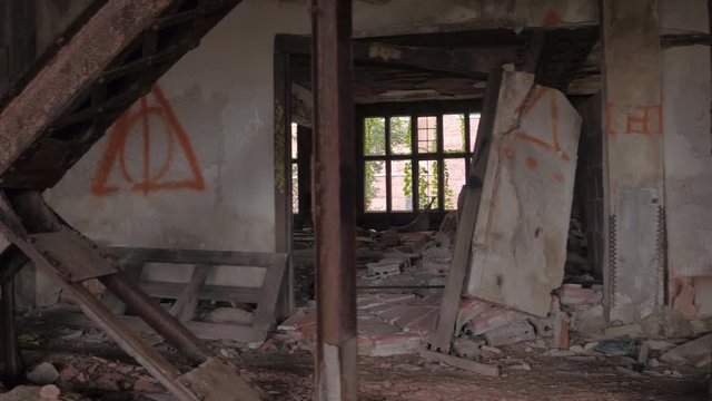 CLOSE UP: Exploring scary dark rooms & corridors in abandoned demolished house. Debris & destruction in creepy crumbling hotel in a ghost town. Badly weathered floors in children's asylum collapsing