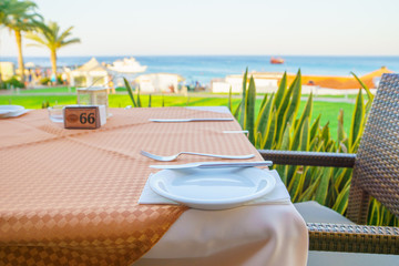 restaurant table and setting place with romantic sea view
