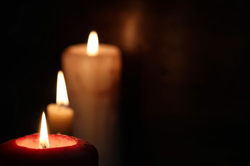 Burning candle flame in the dark