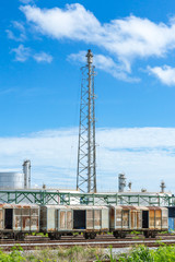 Fototapeta premium Refinery tower in petrochemical industrial plant with blue sky