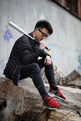 Asian young man on the street posing at the camera