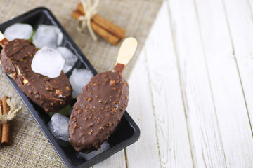 Dessert chocolate ice cream with nuts on wooden stick