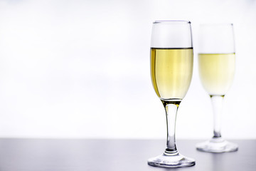 glass of white wine on a table on white background isolate