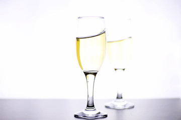glass of white wine on a table on white background isolate