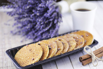 Viennese wafers with caramel on a wooden background