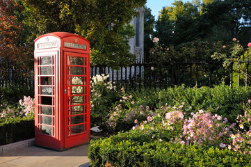 Red phone booth in the park. London, UK.