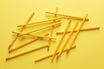 Plenty of pencils against yellow background .