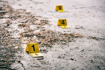 Crime scene markers on dirty ground