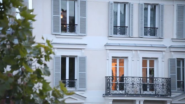 typical building facade exterior in Paris, establishing shot