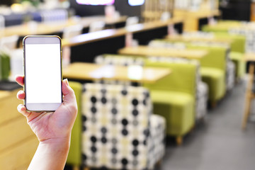 Hand holding smartphone for finding the restaurant shop