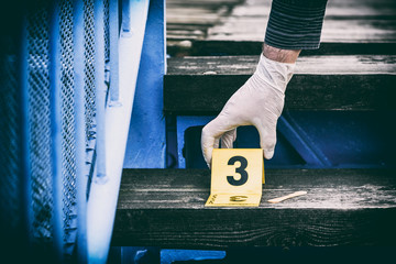 Crime scene investigation, putting the crime scene marker on wood stairs