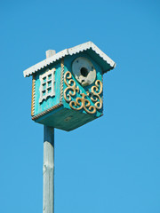 Beautiful birdhouse on blue sky background