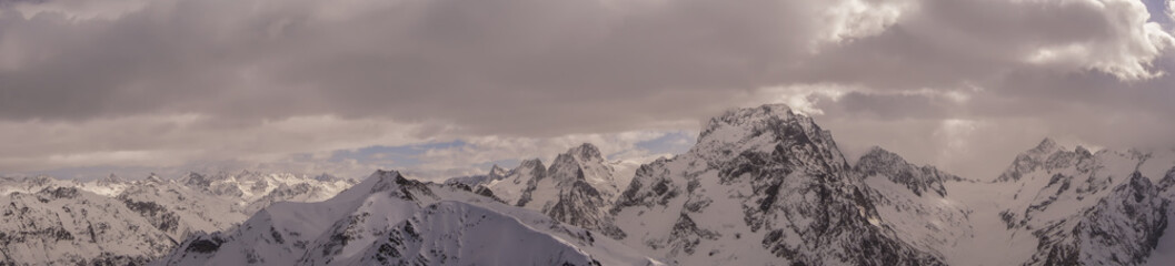 Fototapeta na wymiar Panorama of the snow-capped mountains. the majestic mountains 