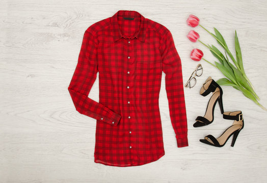 Red checkered blouse, tulips, glasses, lipstick. Fashion concept