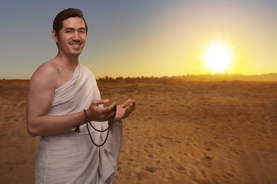 Handsome asian muslim man in ihram dress with prayer beads