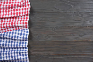 blue and red cloth on dark wooden background with copy space. Top view.