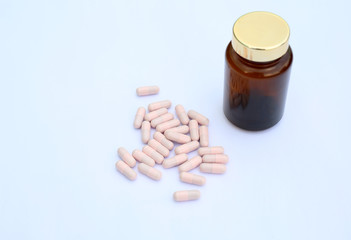 capsule and bottle on white background.
