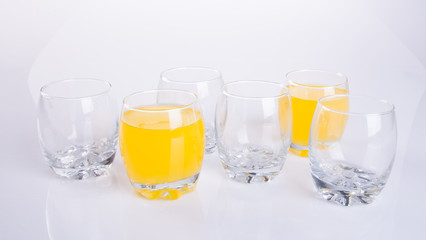 Orange juice in glasses on white background.