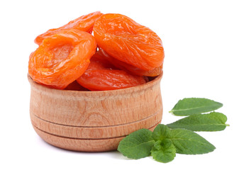 dried apricot in wooden bowl isolated on white background