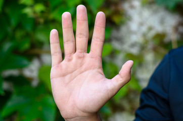 Male hand is showing five fingers
