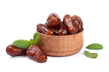 date fruit in wooden bowl isolated on white background