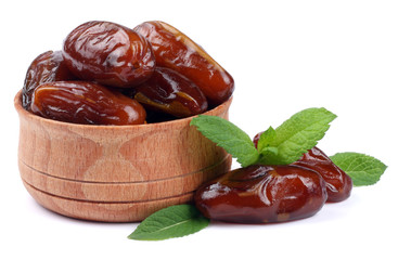 date fruit in wooden bowl isolated on white background