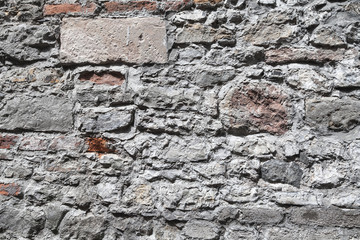 Old grungy gray and red brick wall