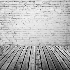 White brick wall and gray wooden floor