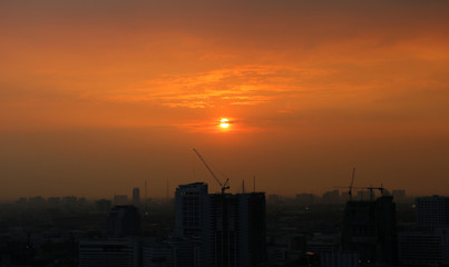 Sunset and clouds background in the evening, city downtown with sunset sky.