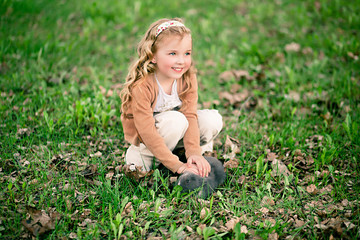 pretty girl plays with small rabbit