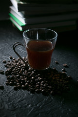 coffee cup and coffee beans on the background of books
