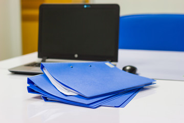 file folder with documents and Notebook background  on white table in meeting room