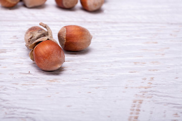 Healthy Hazelnuts on white wooden background in studio photo. Healhty snacks