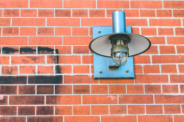 Metall lamp fixed on a brick wall