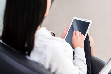 Modern business women holding tablet and toucing it