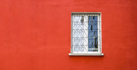 Fototapeta na wymiar Window on red wall