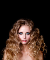 Naklejka premium Beauty Fashion Model Woman , portrait, hairstyle with creative hair-dress, curls waves. Concept Girl face with perfect skin in dark Background