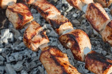 meat on skewers on fire