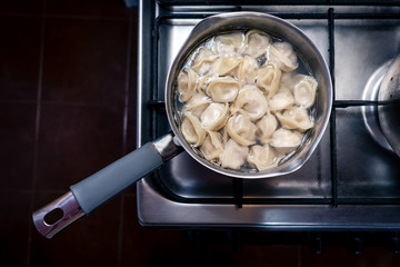 Dumplings are cooked in a saucepan. Russian national dish.