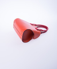 bag or brown leather woman handbag on background.