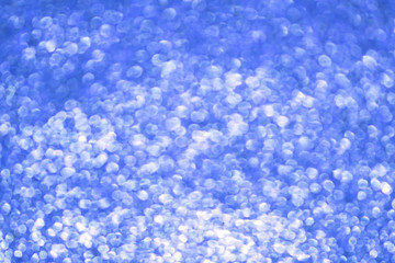 Blue bokeh texture. Festive glitter background with defocused lights