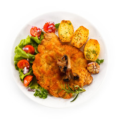 Fried pork chop with potatoes on white background