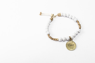 Bracelet with engraved love, on white background .Concept of love .minimalism.