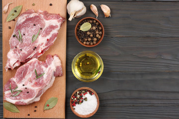 fresh raw meat with spices on wooden table. top view with copy space