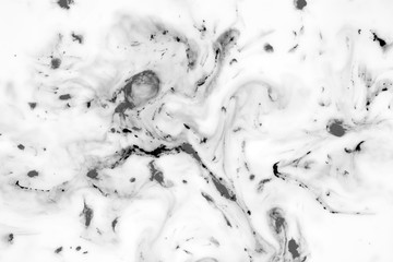 Black and white background with ink on milk texture