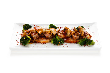 Grilled meat with broccoli and mushrooms on white background