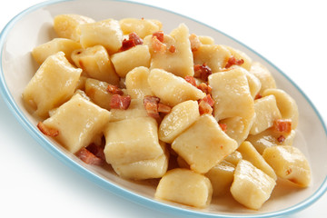 Potato noodles - dumplings on white background