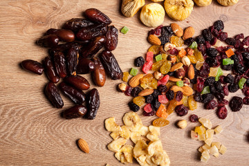 Mix of dried fruits on wooden background in studio photo. Healthy lifestyle